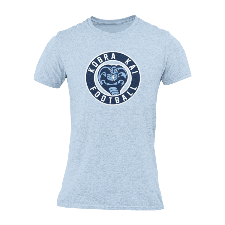 A light blue short-sleeve crewneck t-shirt with a navy blue circular graphic on the chest featuring a snake head and the text 'KOBRA KAI FOOTBALL'.