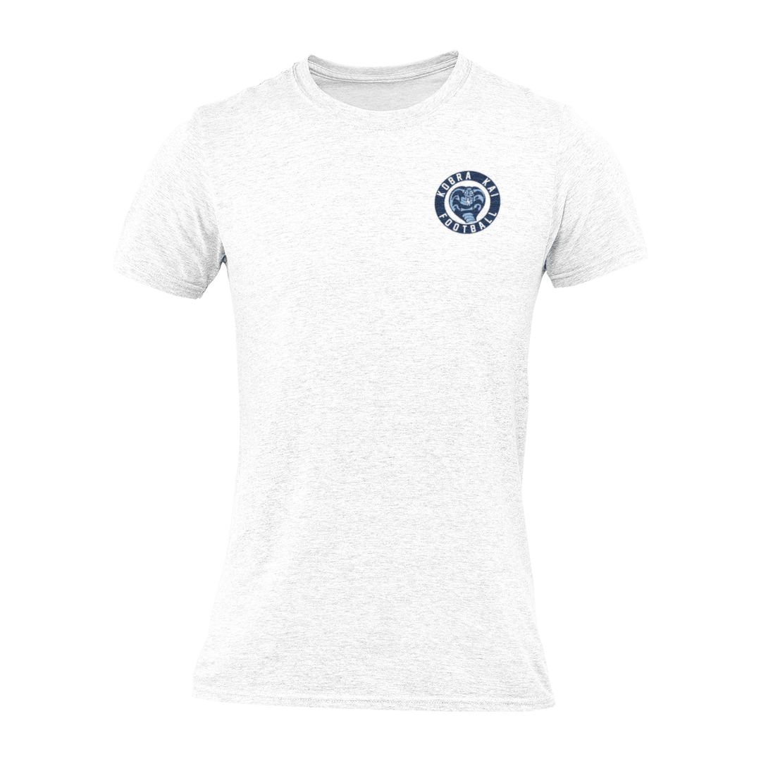 A white short-sleeve crewneck t-shirt with a circular navy blue Kobra Kai Football logo displayed on the upper chest.