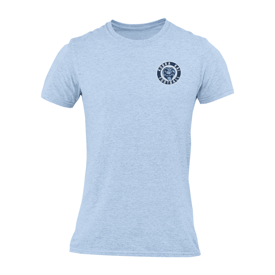 A light blue short-sleeve crewneck t-shirt with a circular navy blue Kobra Kai Football logo displayed on the upper chest.