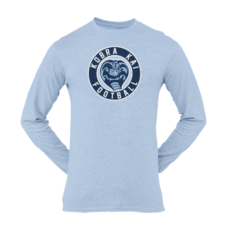 A light heather blue long-sleeve t-shirt with a circular 'KOBRA KAI FOOTBALL' Logo printed on the chest.