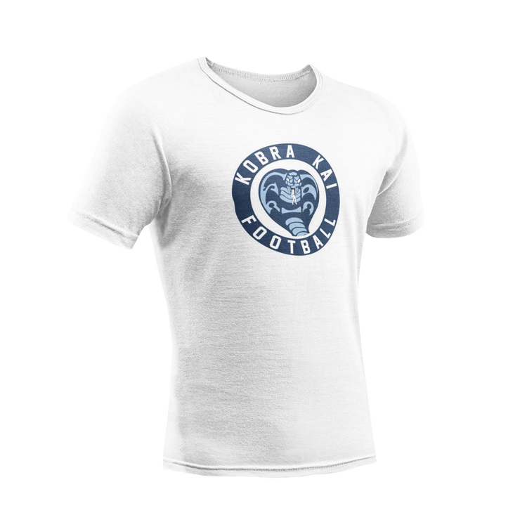 A white short-sleeve crewneck t-shirt featuring a circular navy blue graphic on the chest with a cobra snake and the text 'Kobra Kai Football'.