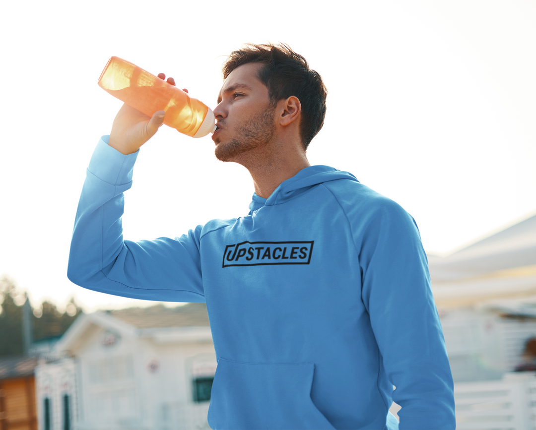 Upstacles Hoodie being worn on a young man drinking from a water bottle to display Upstacles commitment to selling retail